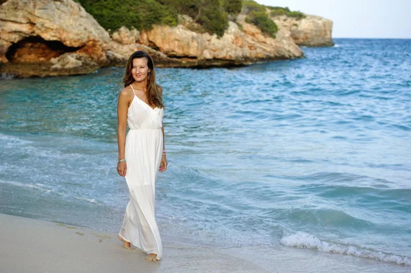 attractive and beautiful woman enjoying vacation summer holidays at Spain coast village walking on beach