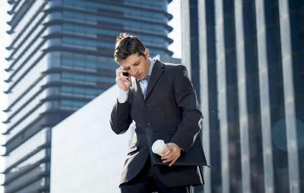 Young attractive businessman in suit and tie talking on mobile phone happy outdoors — Stock Photo, Image