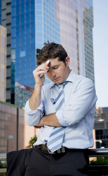 Tired and overworked businessman holding mobile phone worried in stress — Stock Photo, Image