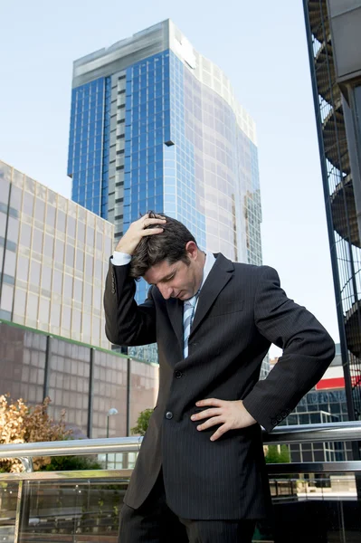 Young exhausted and worried businessman standing outdoors in stress and depression — Stock Photo, Image