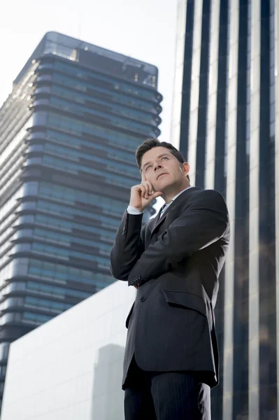 Corporate portrait attractive businessman outdoors thoughtful in business district — 图库照片