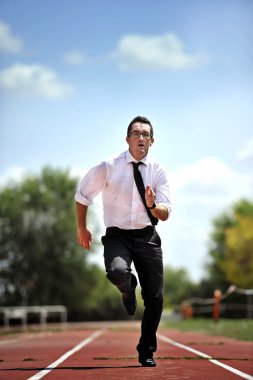 businessman running fast on athletic track in work stress and urgency concept
