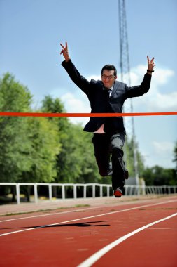 businessman running on athletic track celebrating victory in work success concept