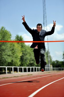 businessman running on athletic track celebrating victory in work success concept clipart