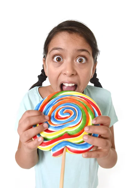 Child holding big lollipop licking with tongue in freak crazy funny face expression — 图库照片