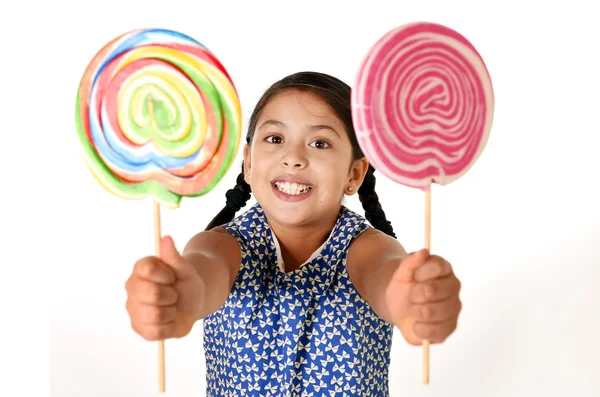 Happy female child holding two big lollipop in crazy funny face expression in sugar addiction — Zdjęcie stockowe