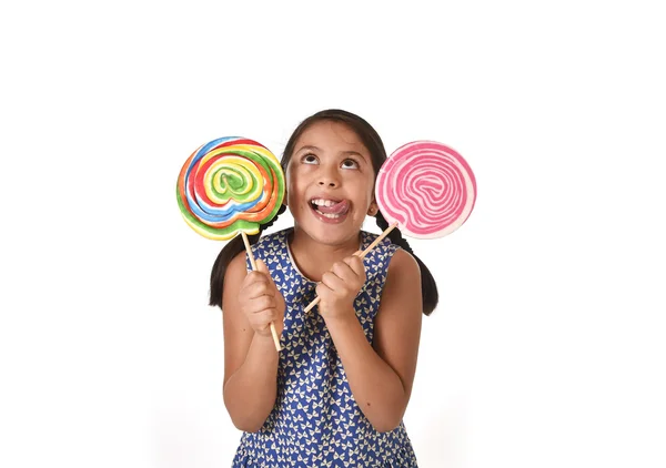 Happy female child holding two big lollipop in crazy funny face expression in sugar addiction — Stock fotografie