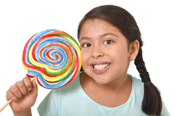 Happy female child holding big lollipop candy in cheerful face expression in kid love for sweet concept — Stock fotografie