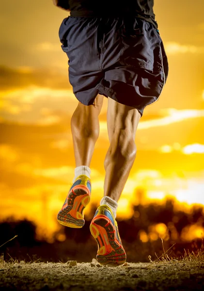 Young man strong legs off trail running at amazing summer sunset in sport and healthy lifestyle — 图库照片