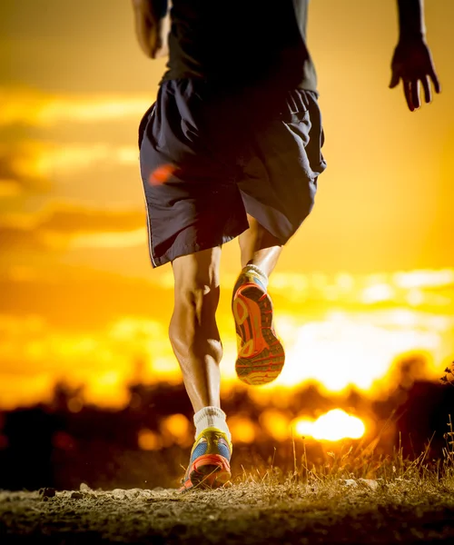 Young man strong legs off trail running at amazing summer sunset in sport and healthy lifestyle — 图库照片