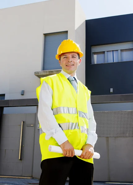 Young attractive foreman worker supervising building blueprints outdoors wearing construction helmet — Stok fotoğraf