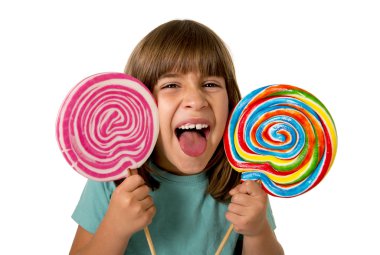 beautiful happy female child having fun eating big lollipop spiral candy with  funny face expression