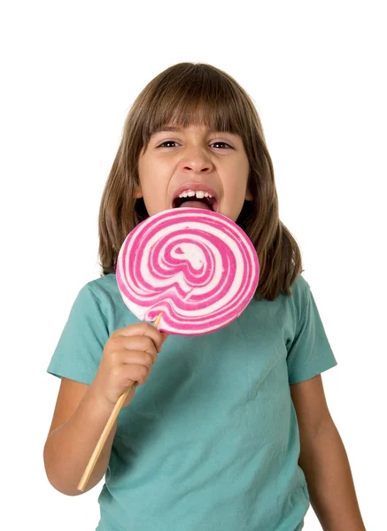 4 or 5 years old child girl eating big pink lollipop candy isolated on white background — Stok fotoğraf