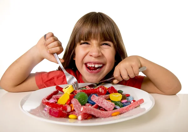 Child eating candy like crazy in sugar abuse and unhealthy sweet nutrition concept 스톡 사진