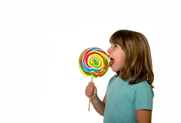 Child eating big lollipop candy isolated on white background in children love sweet sugar concept and dental health care concept — Stock fotografie