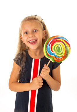 beautiful female child with long blond hair holding huge spiral lollipop candy smiling happy