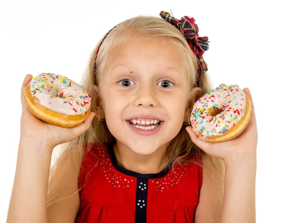 Pretty little female child holding two sugar donuts smiling happy in children love eating sweet — Stock Fotó