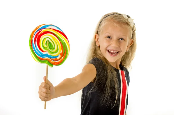 Beautiful little female child with sweet blue eyes holding huge lollipop spiral candy smiling happy — Zdjęcie stockowe