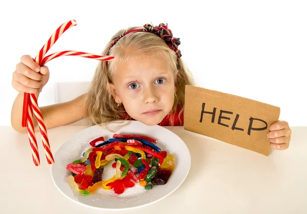 Little female child nutrition abuse of sweet and sugar in candy unhealthy food asking for help — Stockfoto