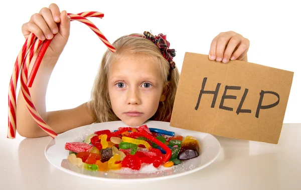 Little female child nutrition abuse of sweet and sugar in candy unhealthy food asking for help — Stockfoto