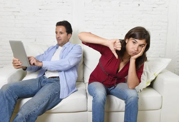 Woman bored and frustrated ignored while internet addict husband or boyfriend using digital tablet networking — Stockfoto