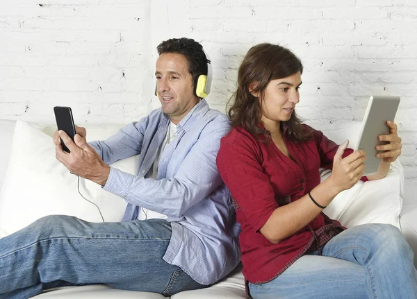 Couple on couch ignoring each other using mobile phone and digital tablet in internet addiction — Stock fotografie