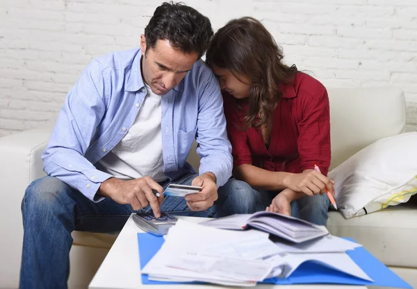 Young couple worried and desperate on money problems at home in stress accounting bank payments — Stock Photo, Image