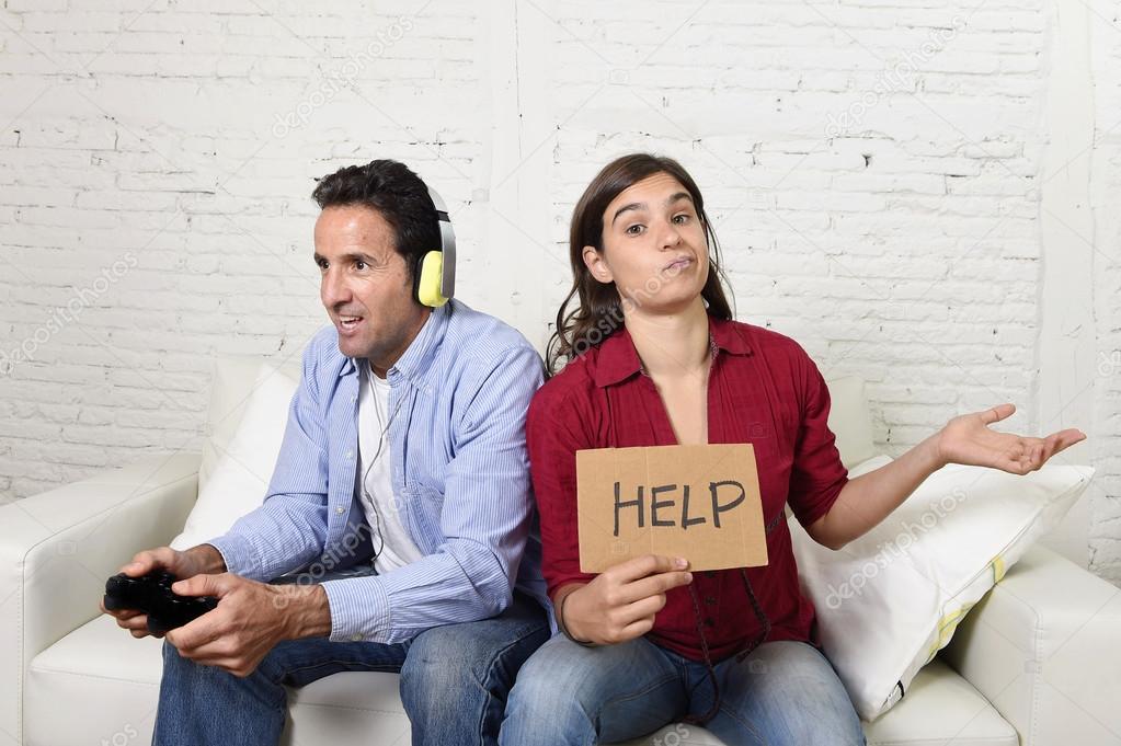 woman asking for help angry upset while husband or boyfriend plays videogames ignoring her