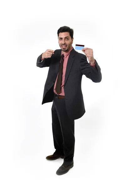 Happy attractive businessman holding credit card in commerce and banking concept — ストック写真