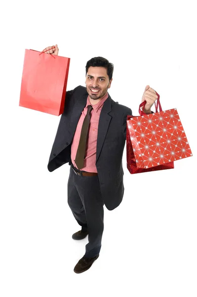 Young attractive businessman holding shopping bags in sale and market opportunity concept — Stockfoto