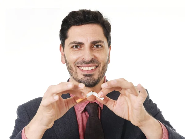 Young hispanic attractive man breaking cigarette in quit smoking resolution — Stock Photo, Image