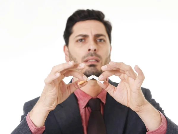 Young hispanic attractive man breaking cigarette in quit smoking resolution — Zdjęcie stockowe