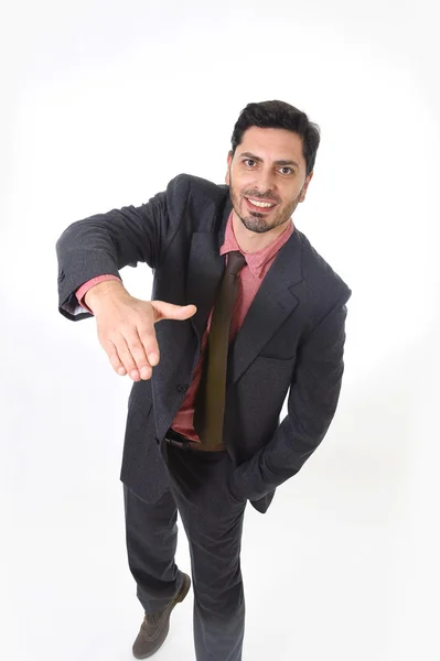 Corporate portrait of young attractive businessman of Latin Hispanic ethnicity giving handshake — Stockfoto