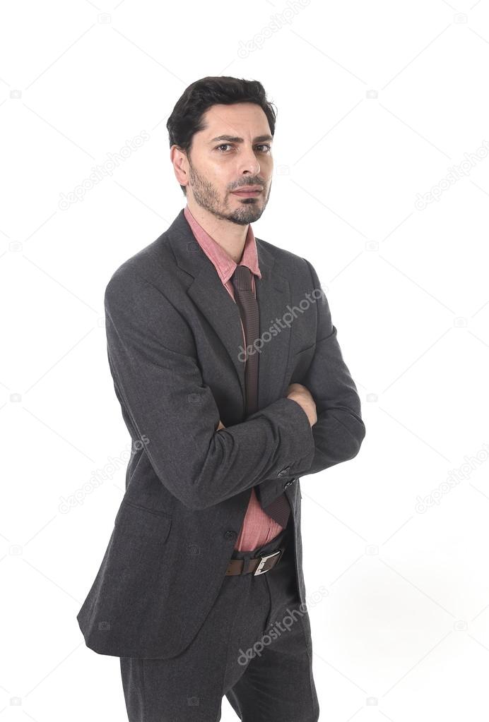 corporate portrait of young attractive businessman of Latin Hispanic ethnicity  in suit and tie with folded arms