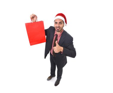 young attractive businessman in Christmas Santa hat holding red shopping bag in December and New year sale