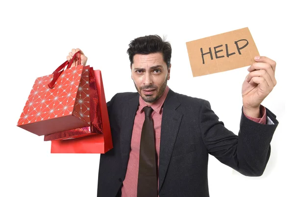 Young attractive business man in stress holding lot of shopping bags and help sign looking tired bored and worried — Stock Photo, Image