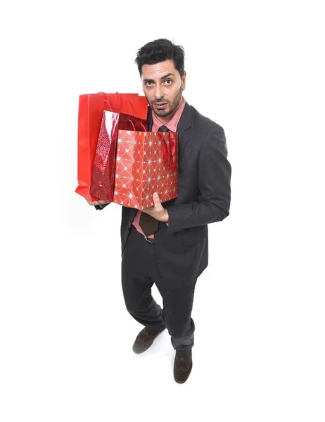 Young attractive business man in stress holding lot of shopping bags and help sign looking tired bored and worried — Stock Photo, Image