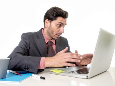 attractive businessman in suit and tie working in stress at office