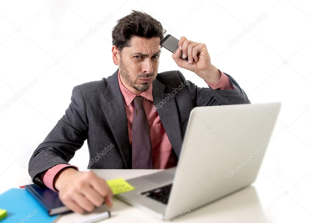 businessman at office working stressed on computer holding mobile phone