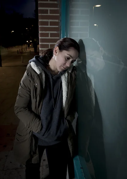 Sad woman alone leaning on street window at night suffering depression crying in pain — Stock fotografie