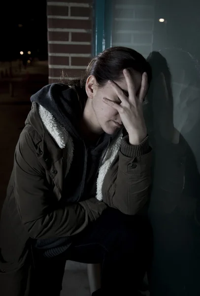 Sad woman alone leaning on street window at night suffering depression crying in pain — Stok fotoğraf