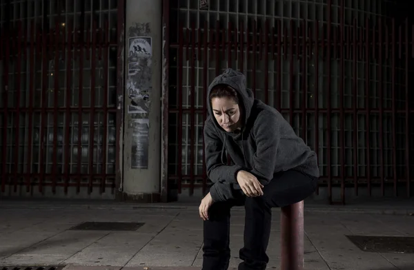 Sad woman alone on street suffering depression desperate and helpless wearing hoodie — Stock Photo, Image