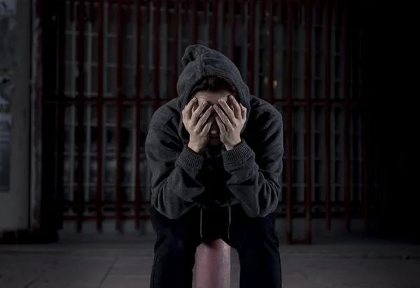 Sad woman alone on street suffering depression desperate and helpless wearing hoodie — Stok fotoğraf