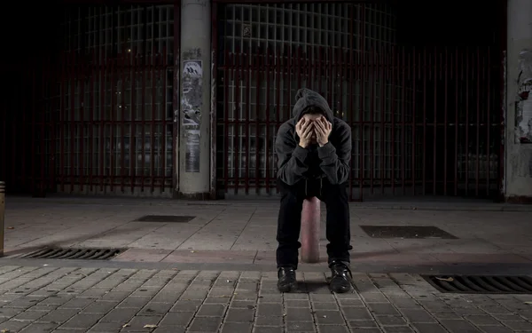 Sad woman alone on street suffering depression desperate and helpless wearing hoodie — Stockfoto