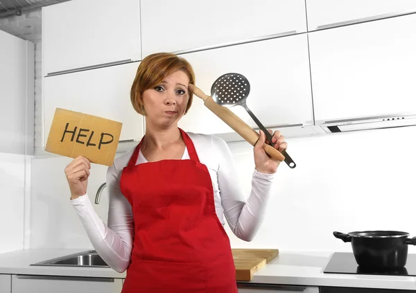 Beautiful cook woman in angry upset and frustrated face expression wearing red apron asking for help holding rolling pin — Stockfoto