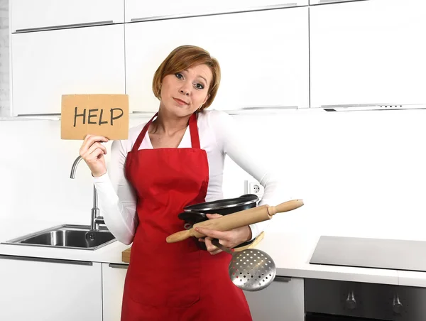 Beautiful cook woman in sad and frustrated face expression wearing red apron asking for help holding rolling pin — Stock Photo, Image