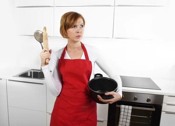 Cook woman in angry upset frustrated face expression in apron ho — Stockfoto