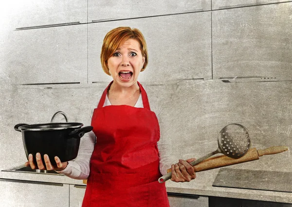 Cook woman desperate in stress in apron holding cooking pot at home dirty edit — Stockfoto