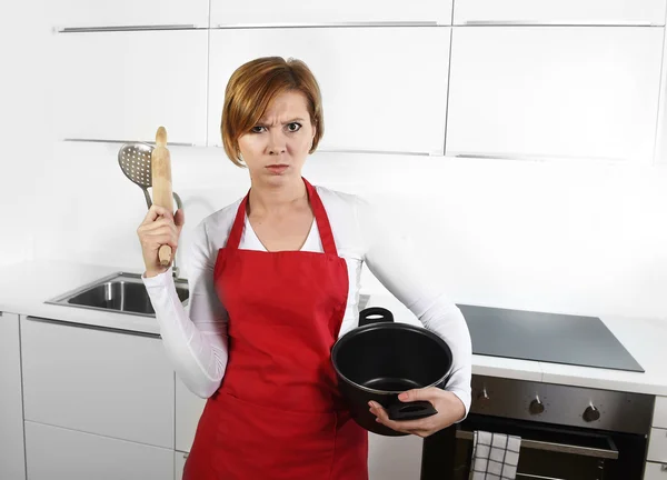 Cook woman in angry upset frustrated face expression in apron ho — Stockfoto