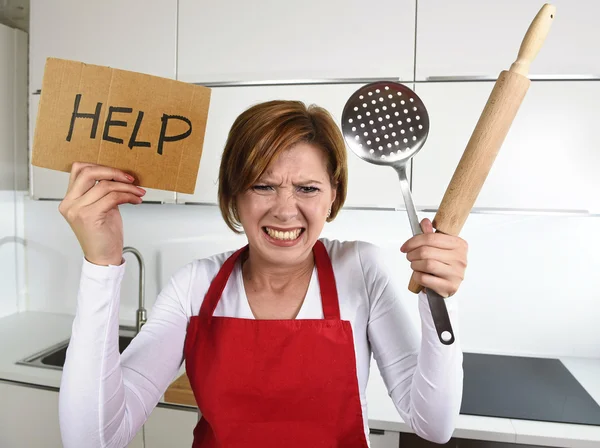 Desperate inexperienced home cook woman crying in stress desperate holding rolling pin and help sign — Stock Fotó